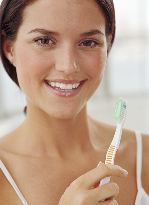 a woman holding a tooth brush 