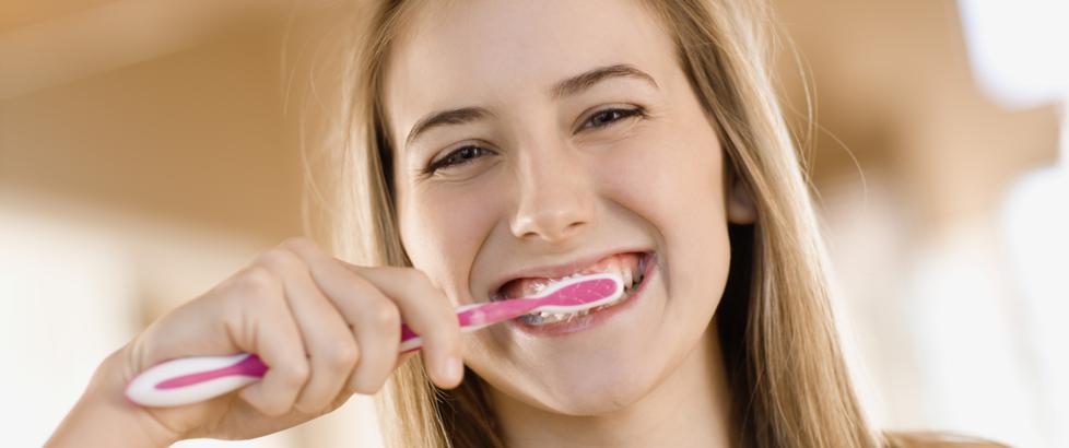 a girl brushing her teeth